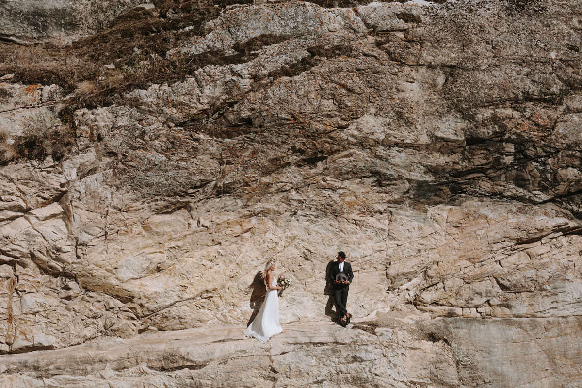 wedding couple posing on a cliffside near god's mountain estate