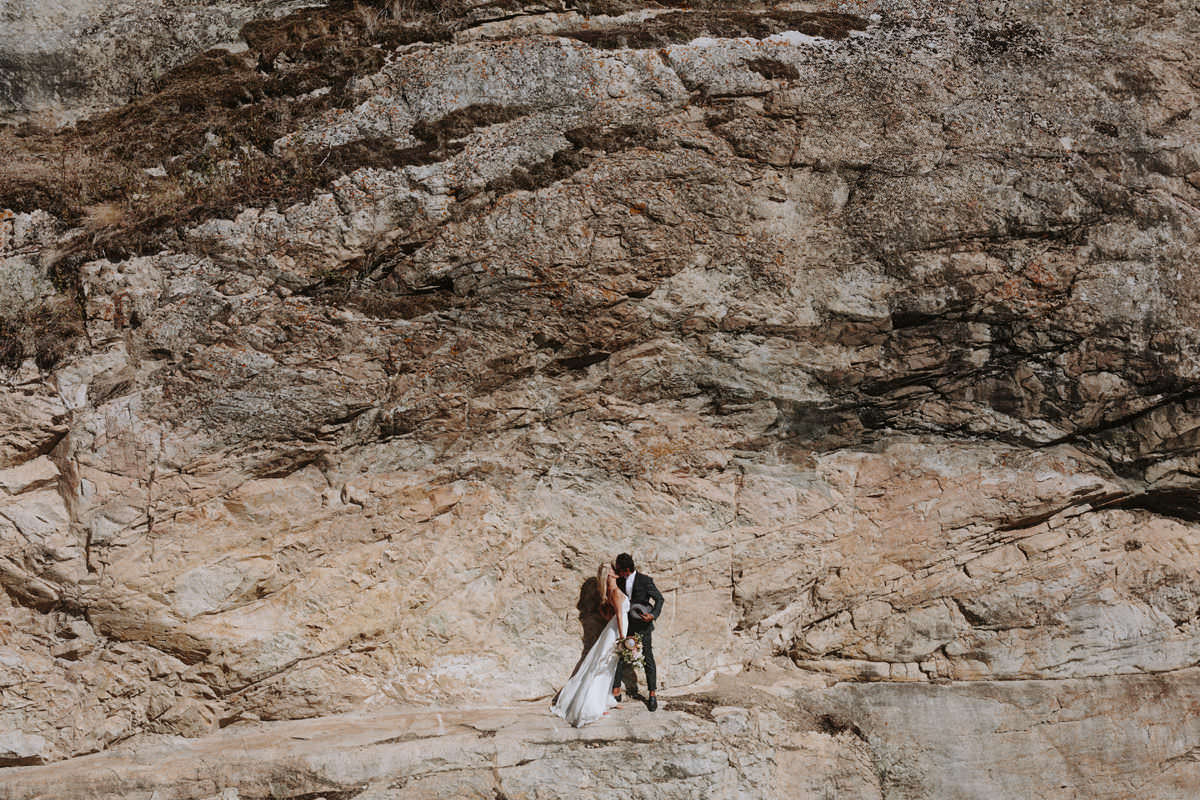 wedding couple posing on a cliffside near god's mountain estate