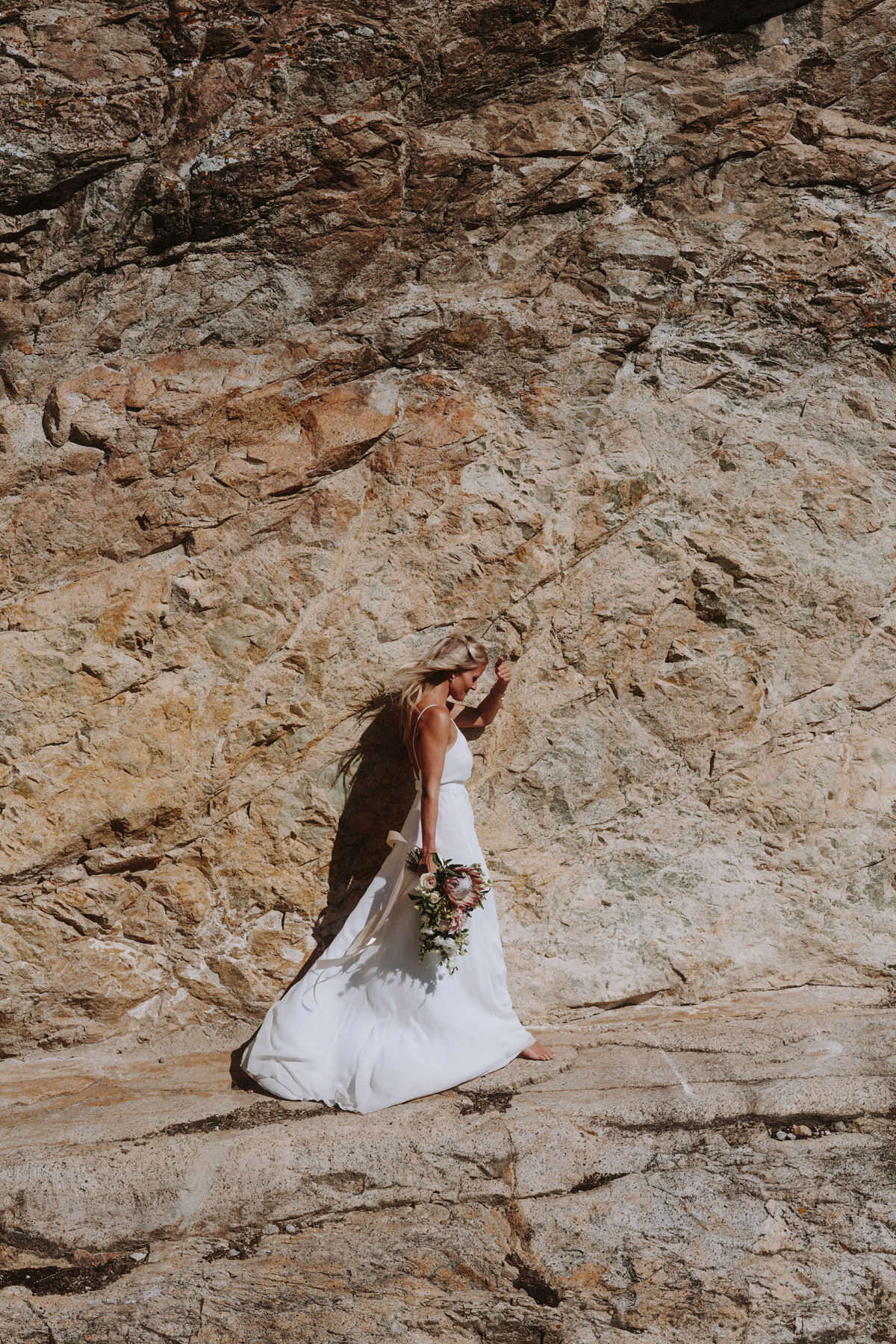 bride posing on a cliffside near god's mountain estate