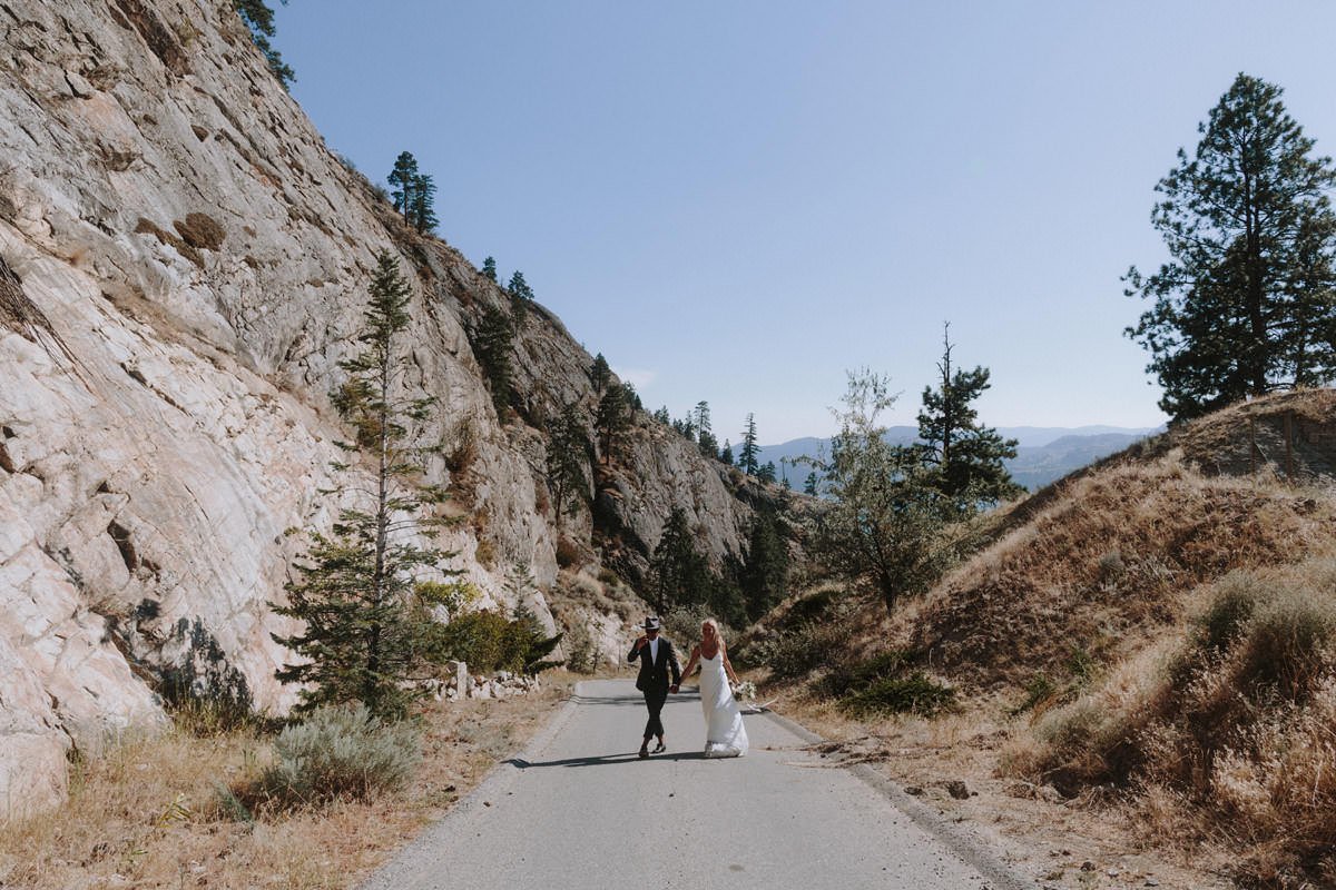 wedding couple posing on a road near god's mountain estate