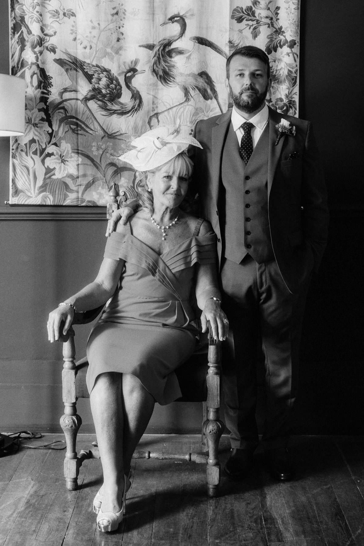 groom posing with his mother inside chateau de lartigolle