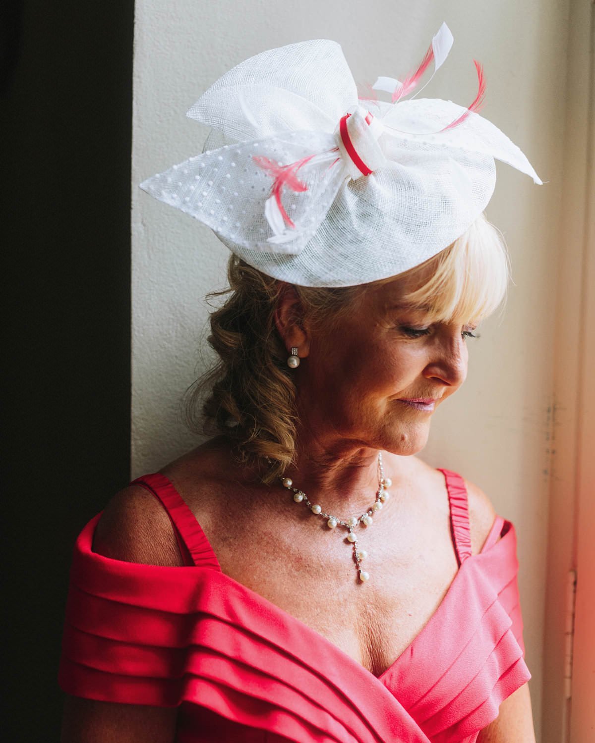 mother of groom in vibrant pink attire