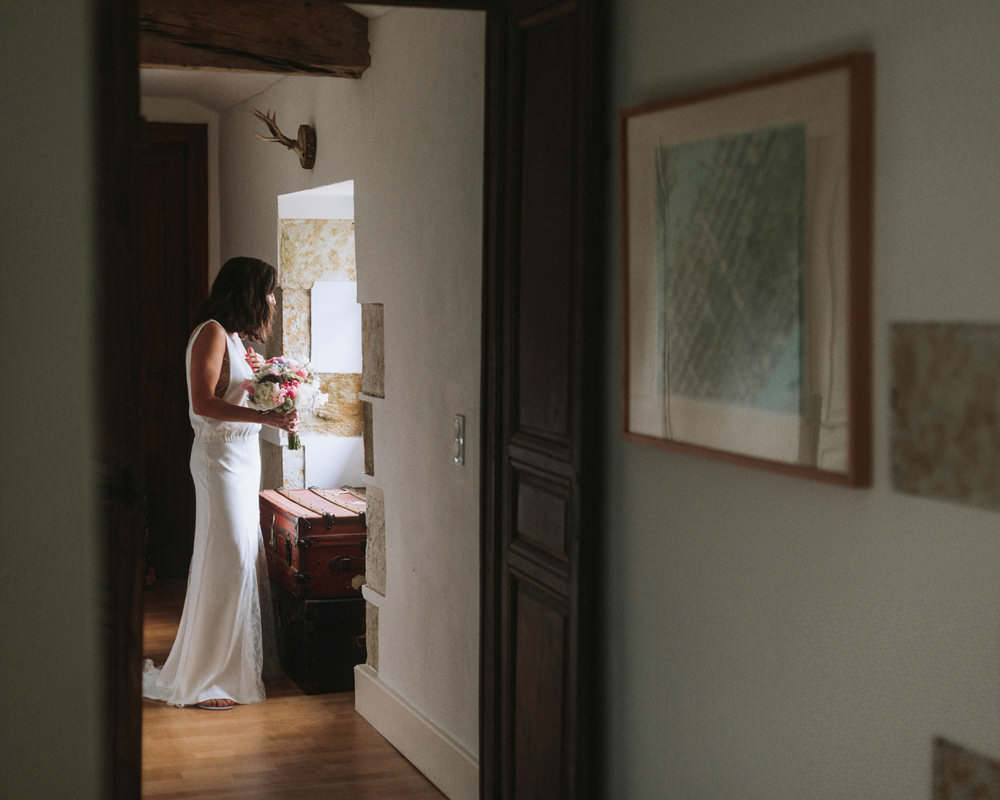 bride looking at her guests while inside chateau de lartigolle