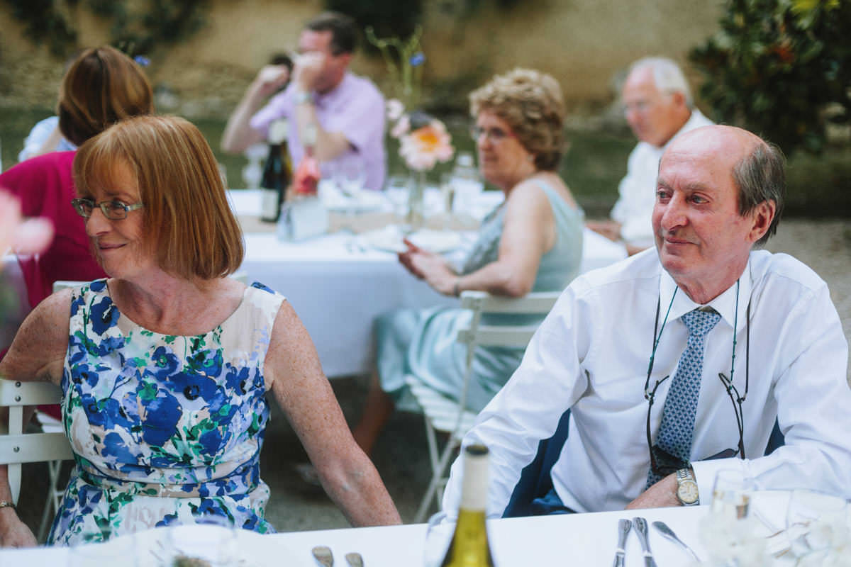 wedding guests at a dinner reception at chateau de lartigolle