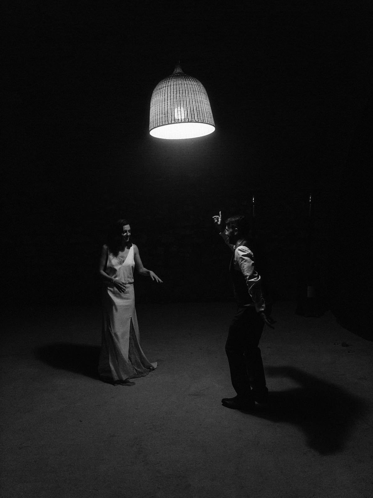 wedding couple dancing under a single light source in france