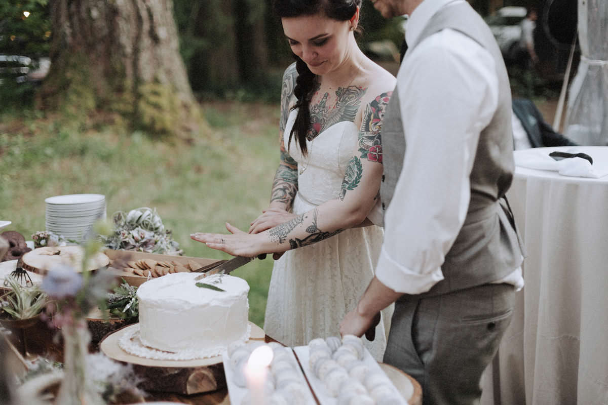 tattooed bride cutting cake whistler