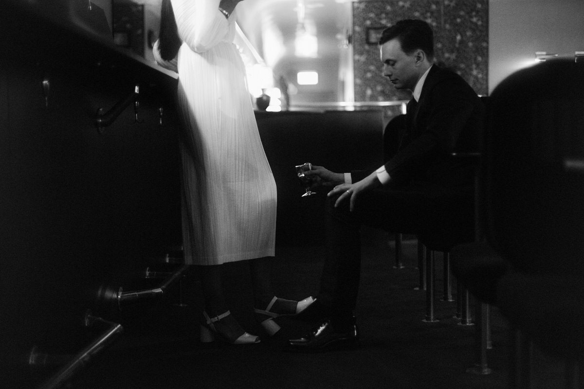 wong kar wai inspired photo of a woman and man flirting inside a dimly lit restaurant