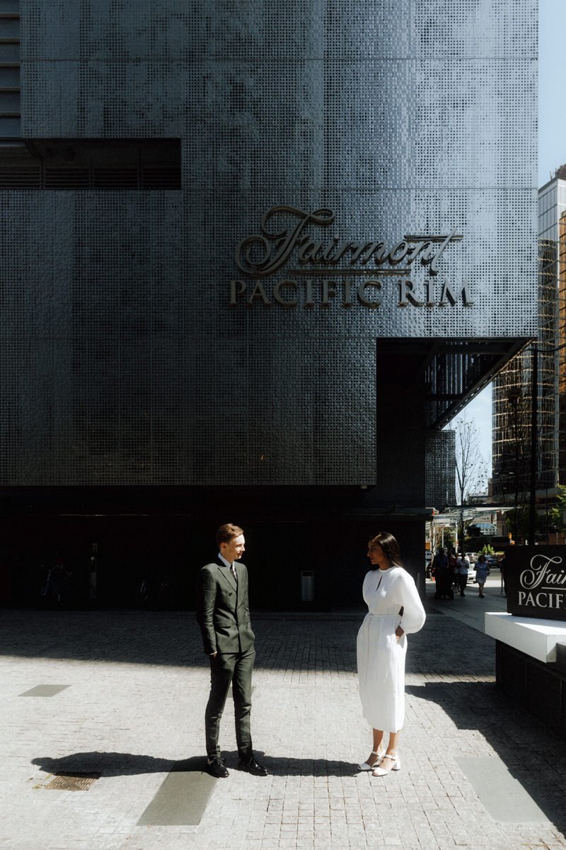 bride and groom standing outside the fairmont pacific rim