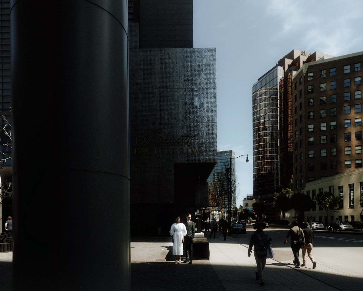 bride and groom standing amongst the architecture at fairmont pacific rim