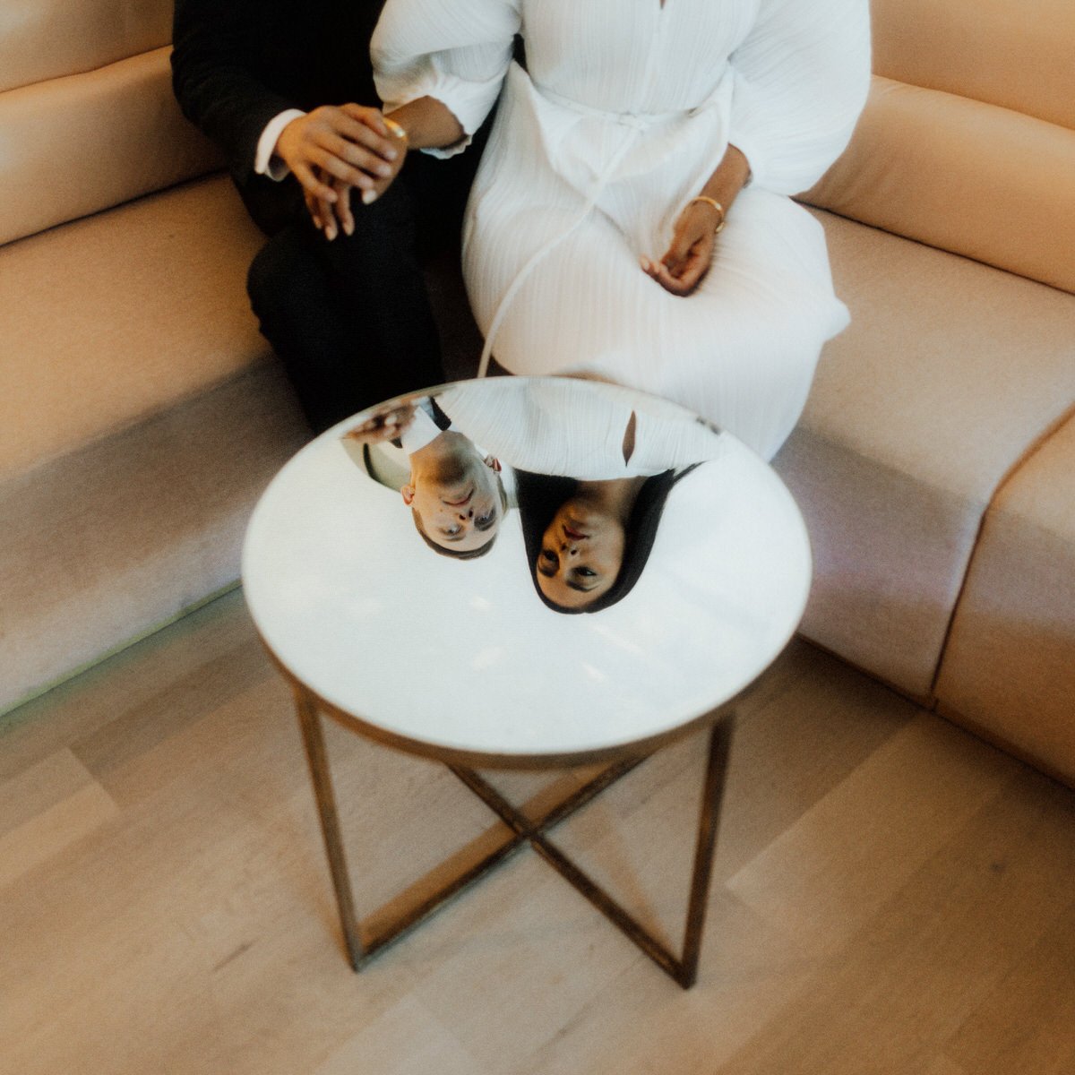 bride and groom reflected in a mirrored round table inside the fairmont pacific rim