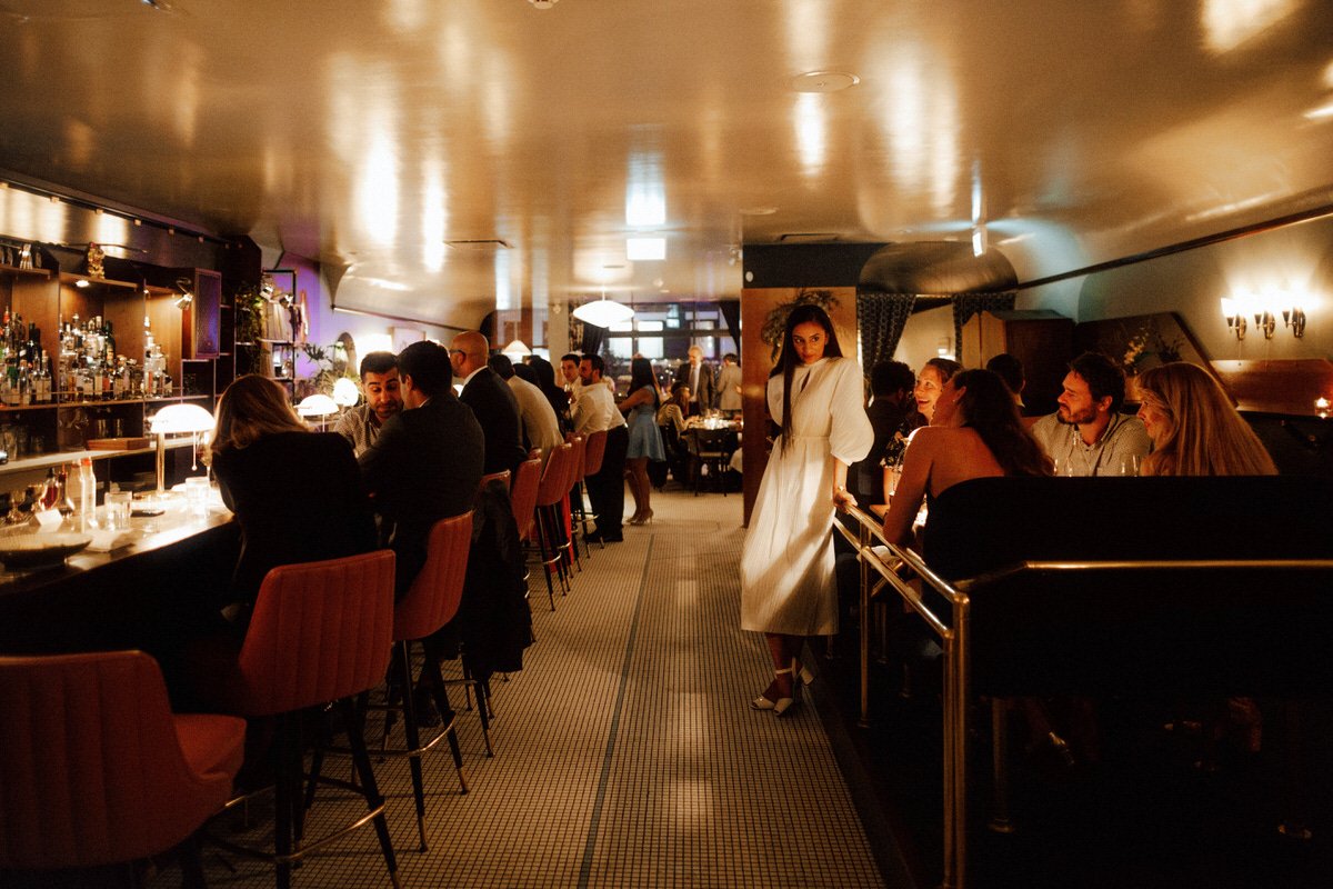 bride chatting to wedding guests inside michelin star restaurant kissa tanto