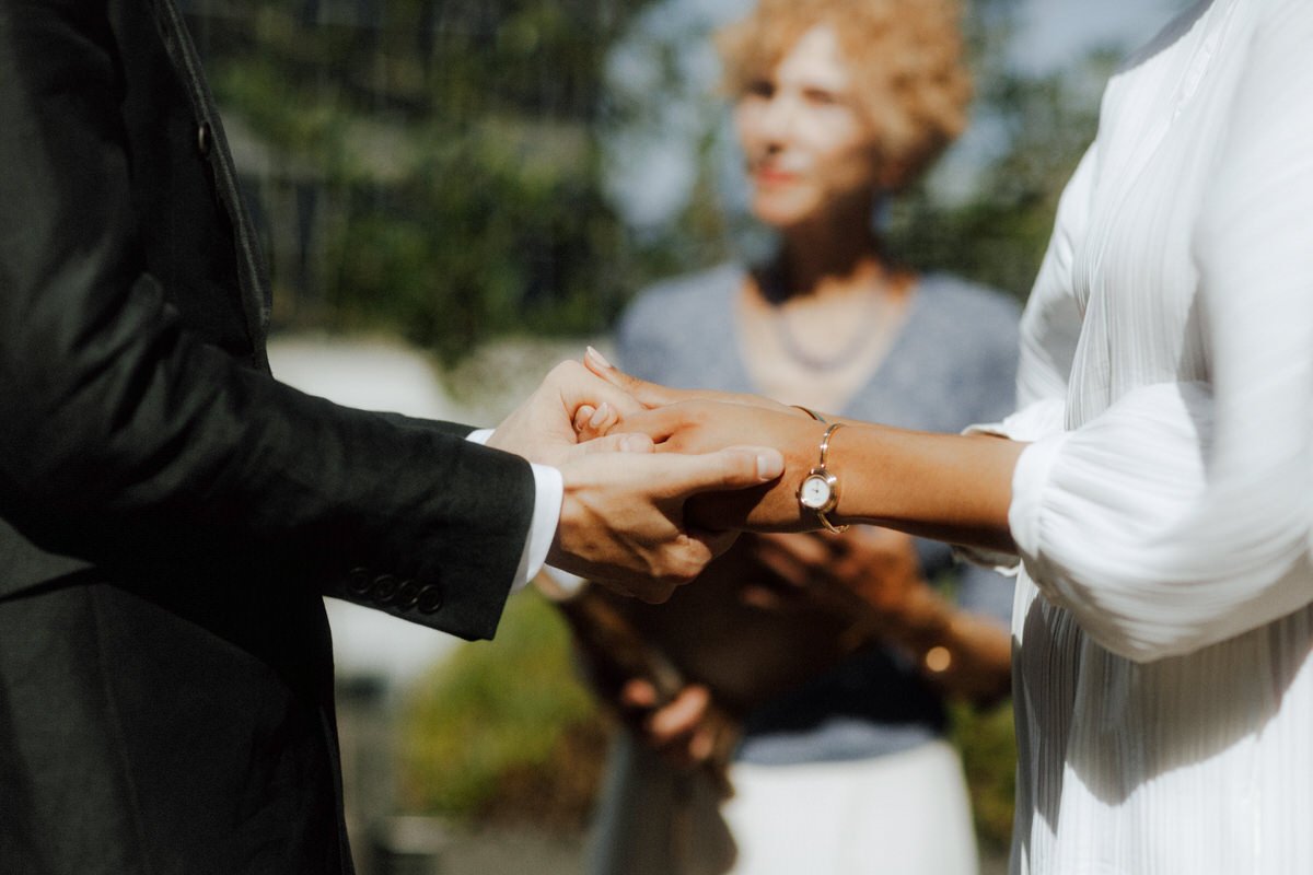wedding couple holding hands during their ceremony at the vancouver club