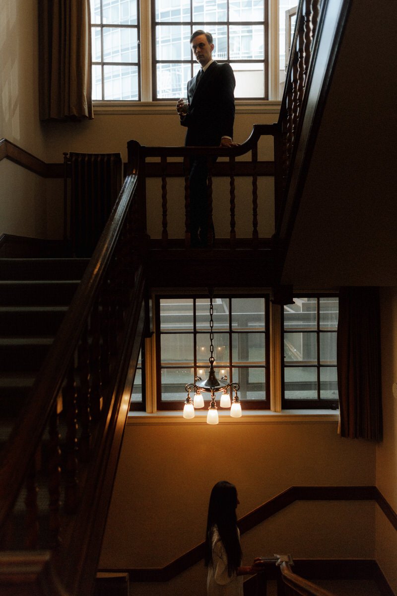 bride and groom posing in the stairwell inside the vancouver club