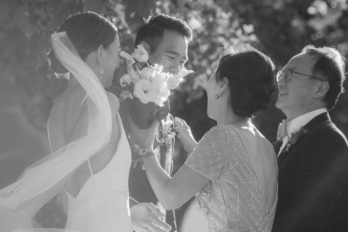 bride and groom giving flowers to their parents during the wedding ceremony in Los Angeles