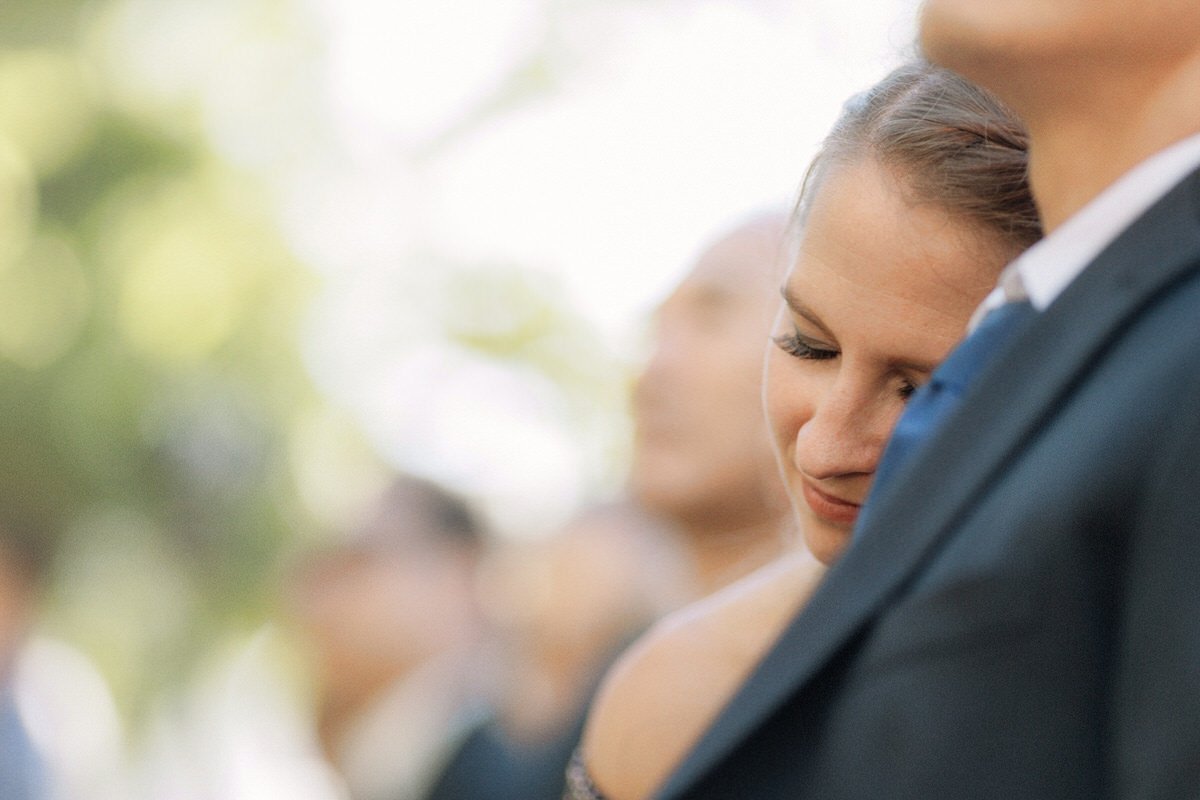 wedding guest rests her head on her husband's shoulder during an emotional wedding ceremony in LA