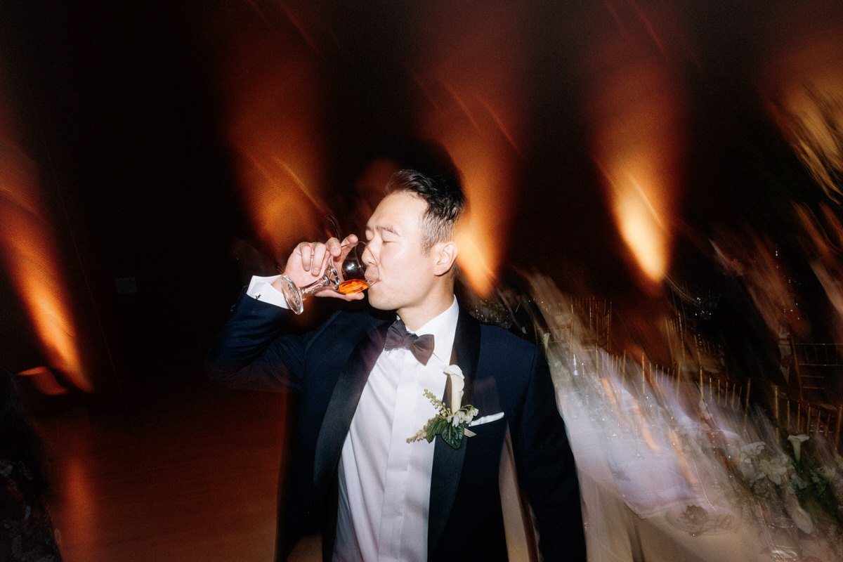 direct flash photo of groom enjoying a glass of wine in LA