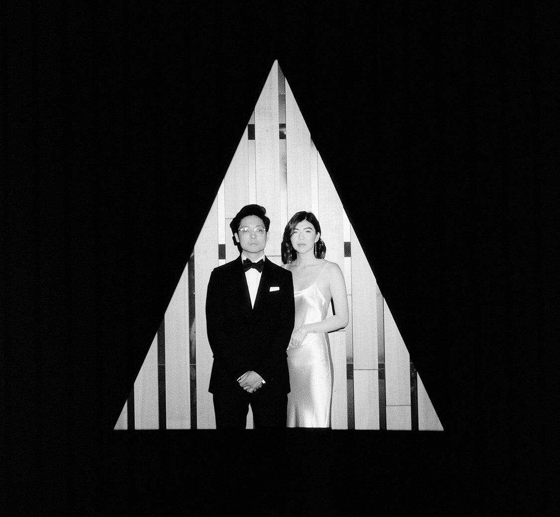 wedding couple standing in a triangle spot light at the audain art museum