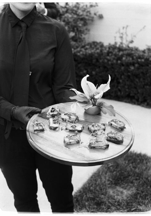 35mm film photo of server holding tray of appetizers during cocktail hour reception