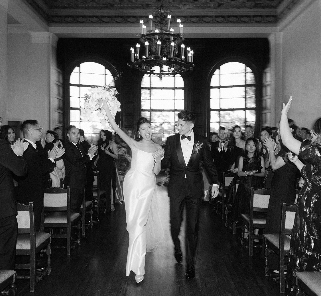 bride and groom walking down the aisle at the ebell of los angeles after their wedding ceremony