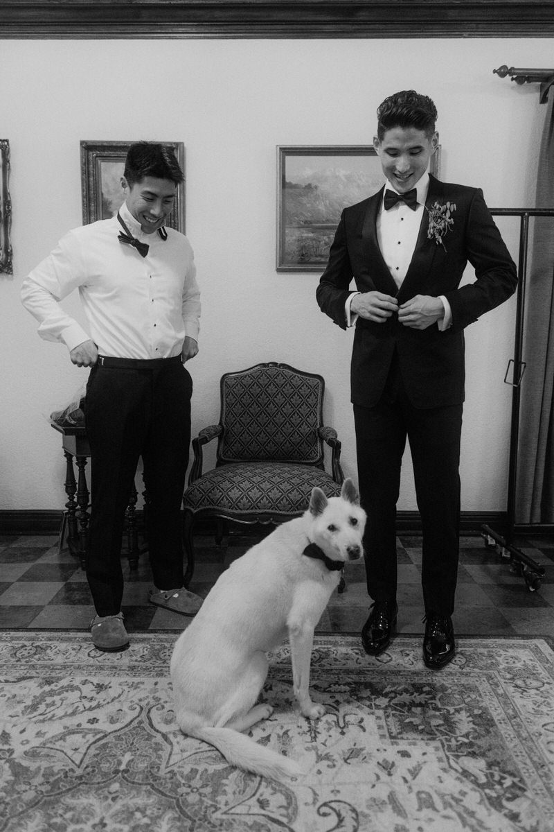 groom gets ready with his Jindo dog inside a dressing room at the Ebell of LA