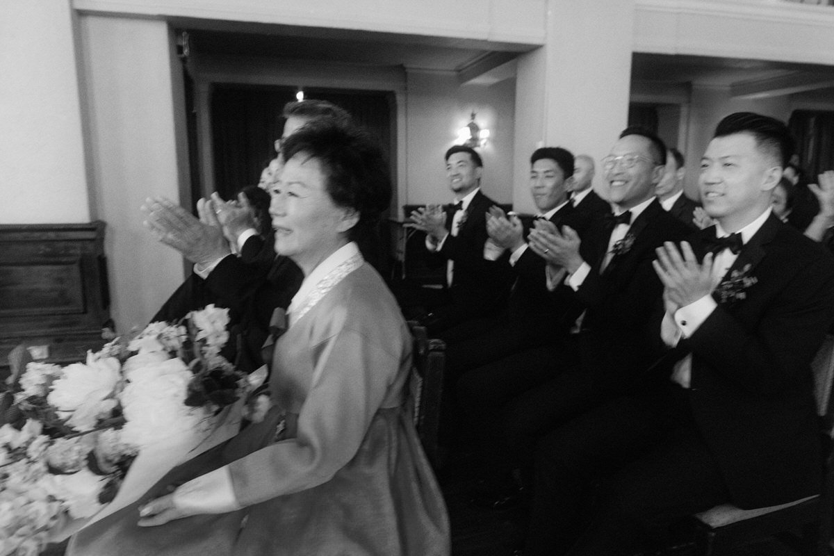 family and guests smiling and clapping during a wedding ceremony in Los Angeles