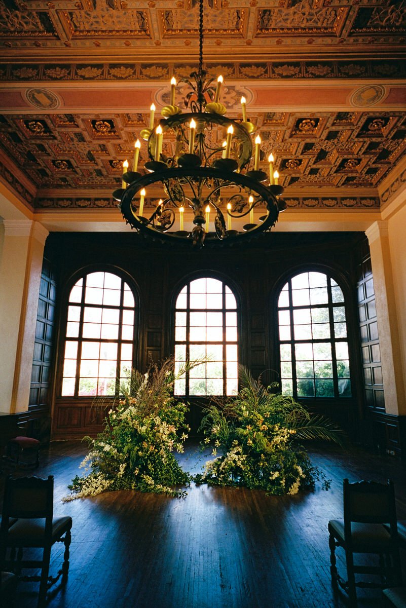 natural green botanical arrangement archway for a wedding ceremony inside the Ebell of LA