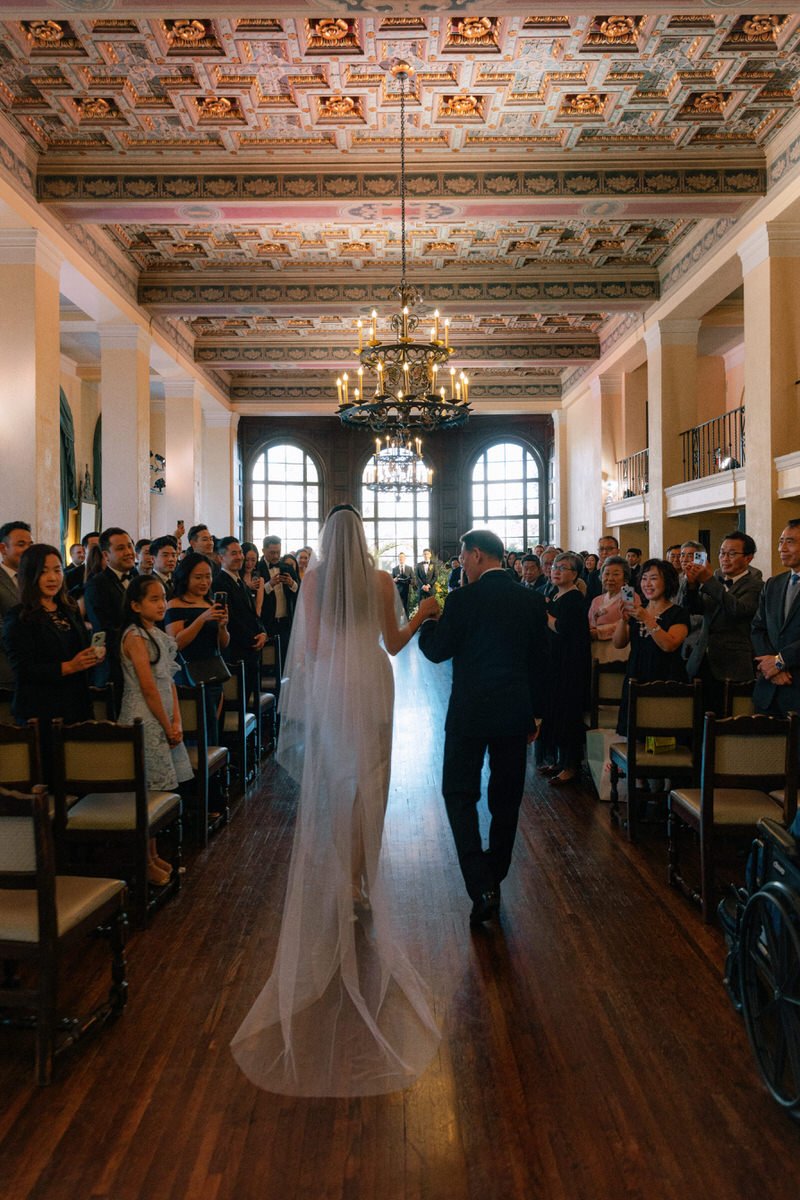 bride walking into the wedding ceremony with her father at Ebell of LA