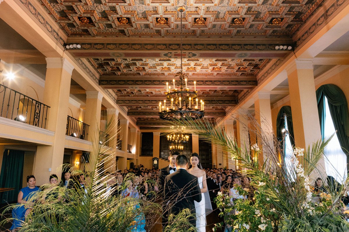 unconventional view of bride and groom and their wedding guests inside the Ebell of LA