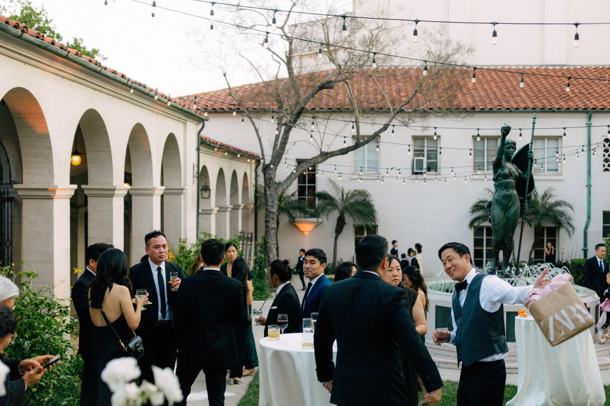 wedding guests enjoying a cocktail reception inside the courtard at Ebell of LA