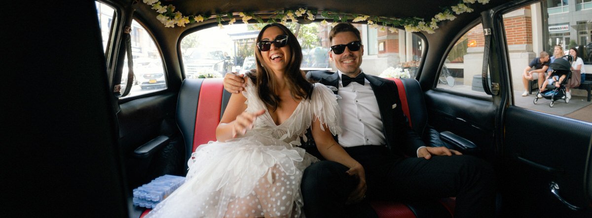 editorial style photo of bride and groom inside a New York taxi cab