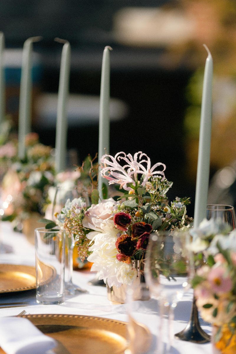 blush coloured florals paired with gold charger plates and mint tapered candles