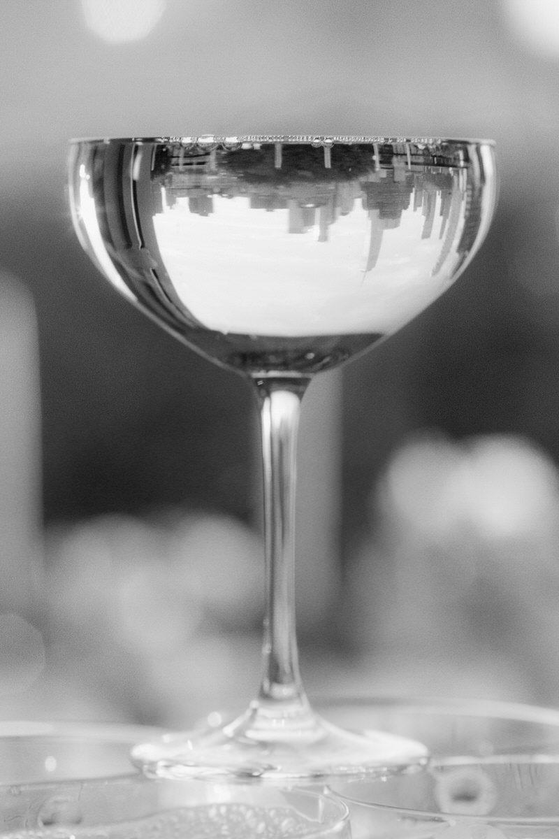 inverted image of NYC skyline reflected in a champagne glass