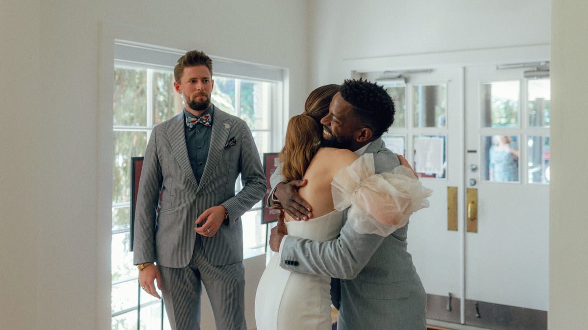 bride greeting wedding guests inside Stanley Park Pavilion
