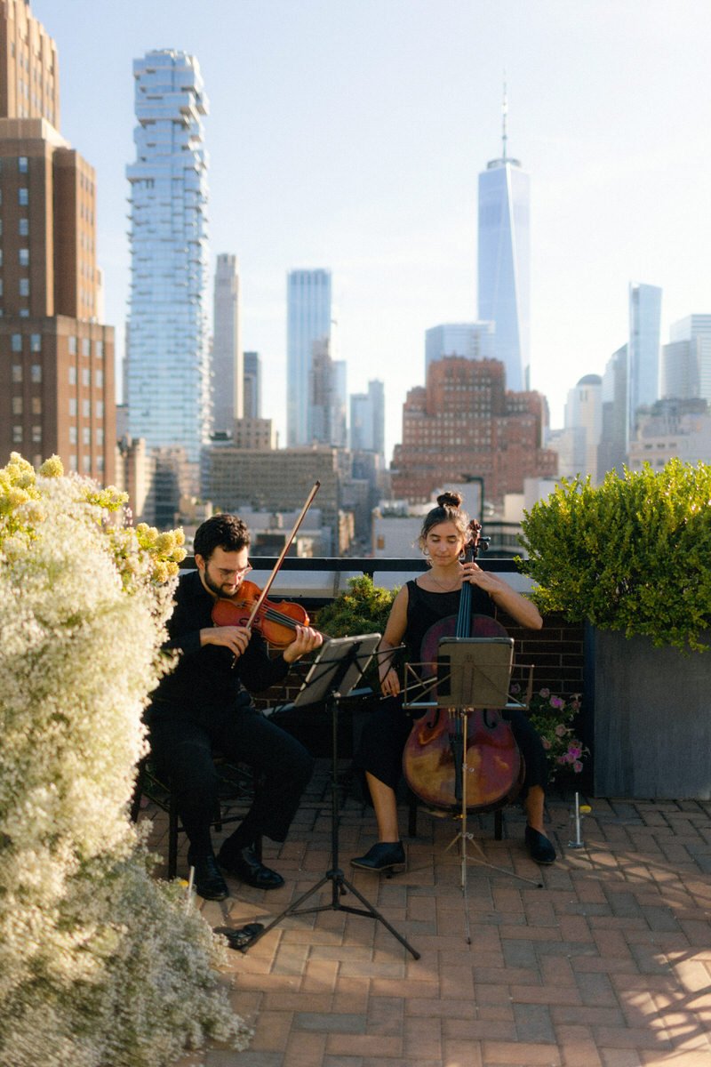 live musicians playing on a Manhattan rooftop prior to the wedding ceremony