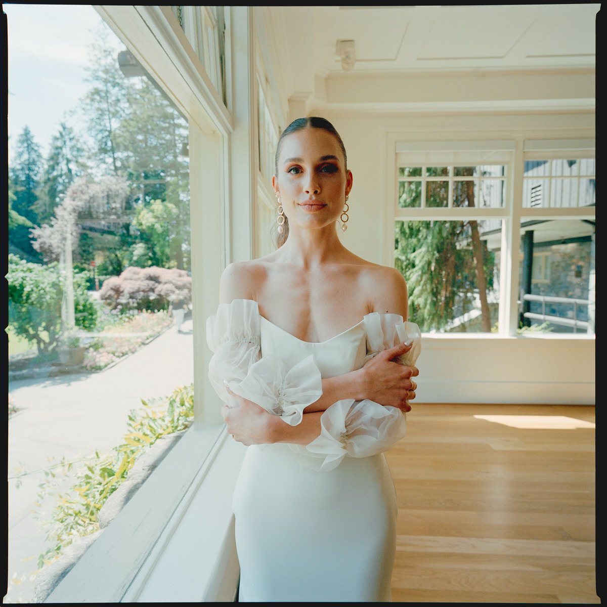 medium format photo of bride wearing Sarah Seven dress and Jennifer Behr earrings