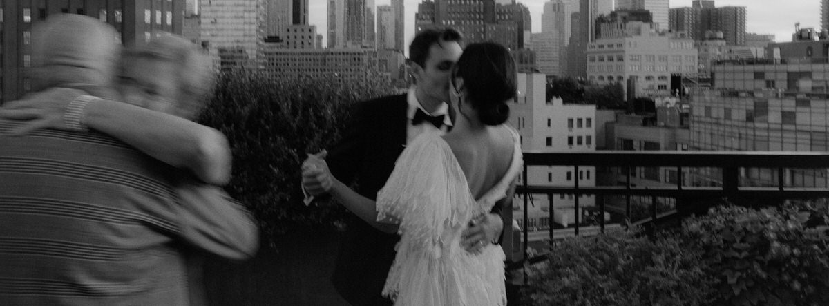 wedding couple sharing a first dance on a Manhattan rooftop