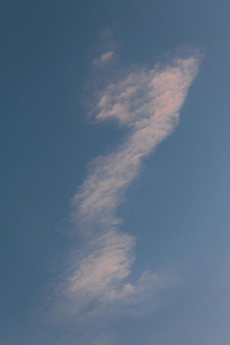 wispy cloud formation over manhattan in the shape of a question mark