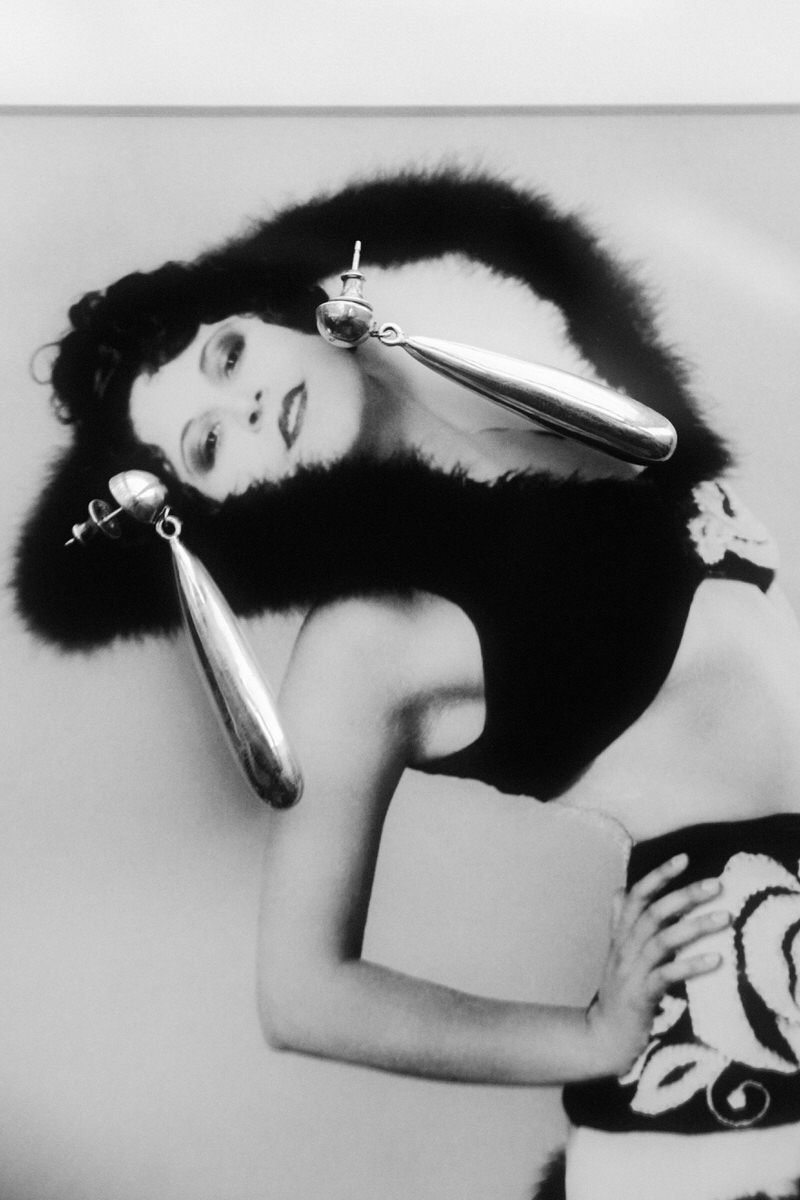 creative layering of drop earrings laying on top of a model photograph