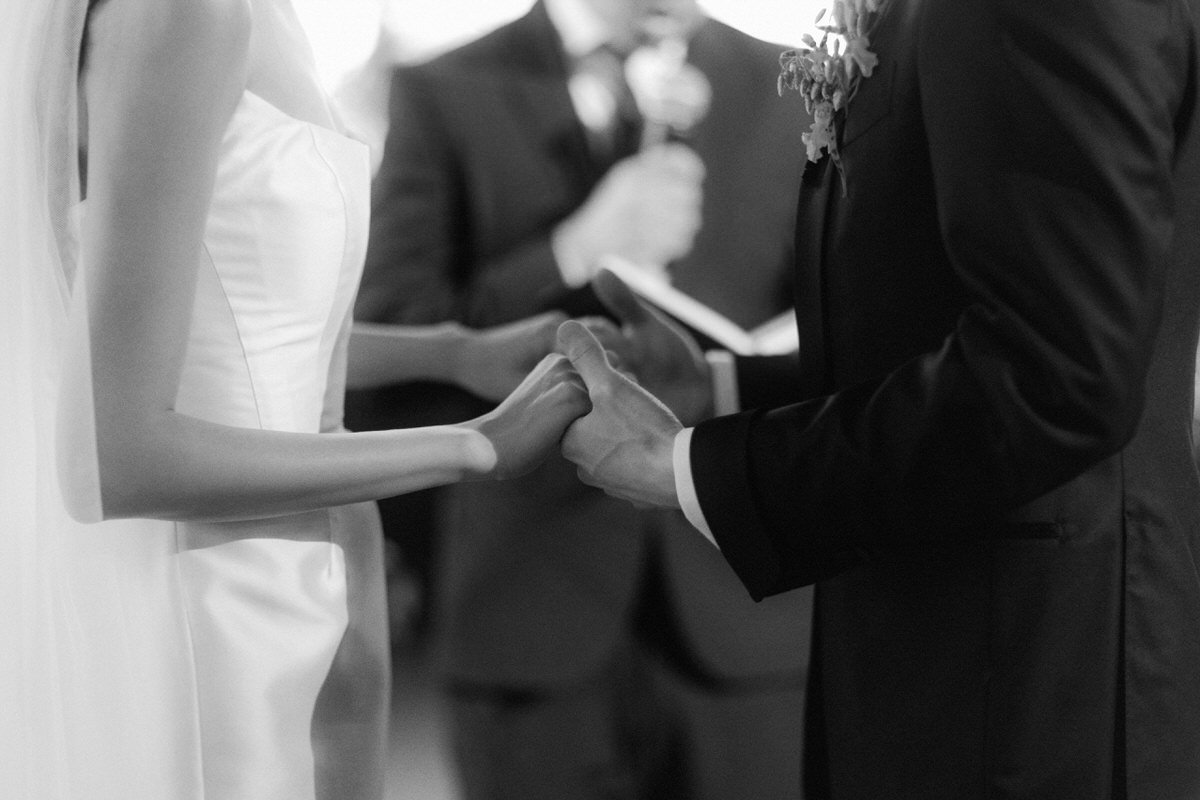 close up view of the bride and groom holding hands during their ceremony at the Ebell of Los Angeles