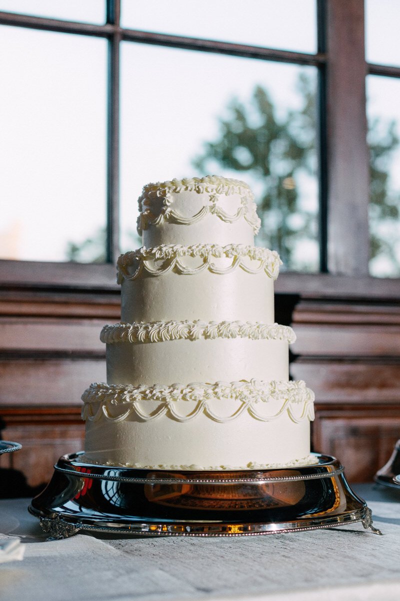 traditional multitiered wedding cake on top of a silver cake stand