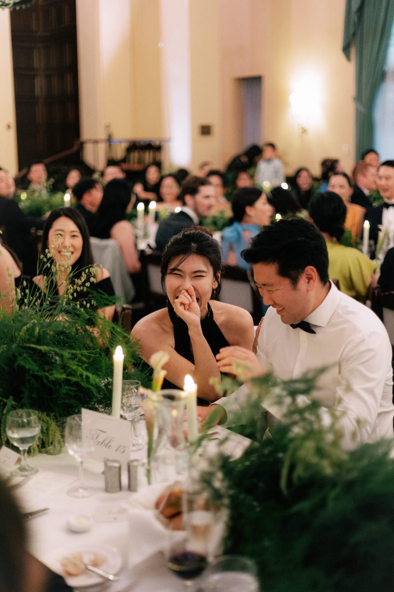 wedding guests laughing during speeches spoken at a wedding reception in Los Angeles
