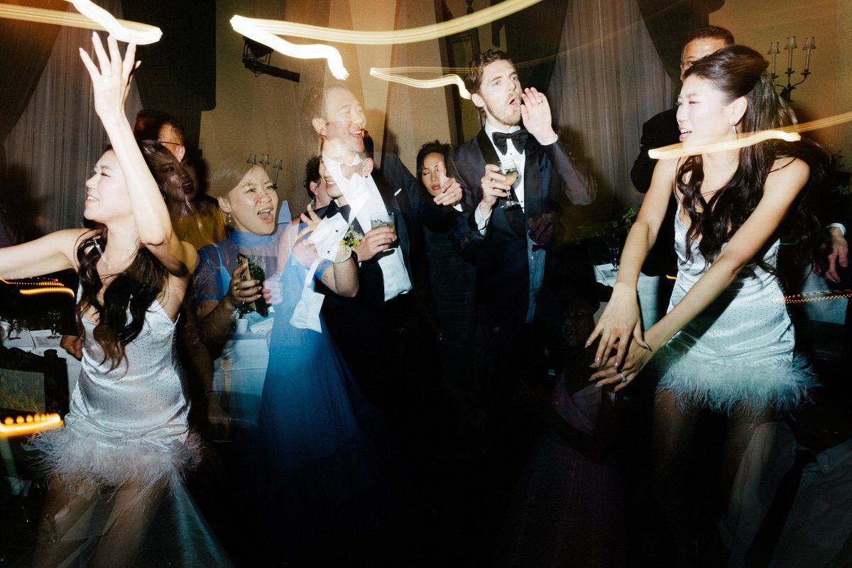 multiple exposure photo with shutter drag of wedding guests dancing