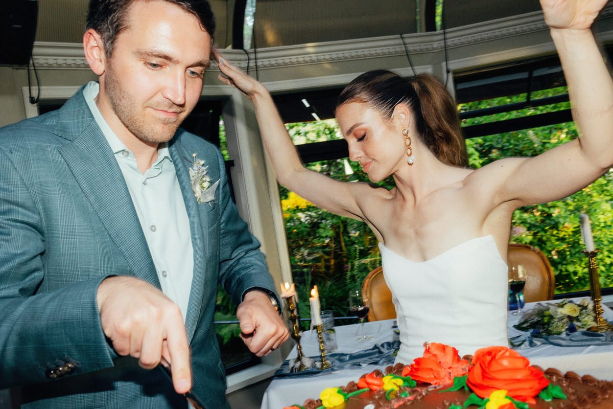 bride and groom cutting cake and dancing inside Teahouse Stanley Park