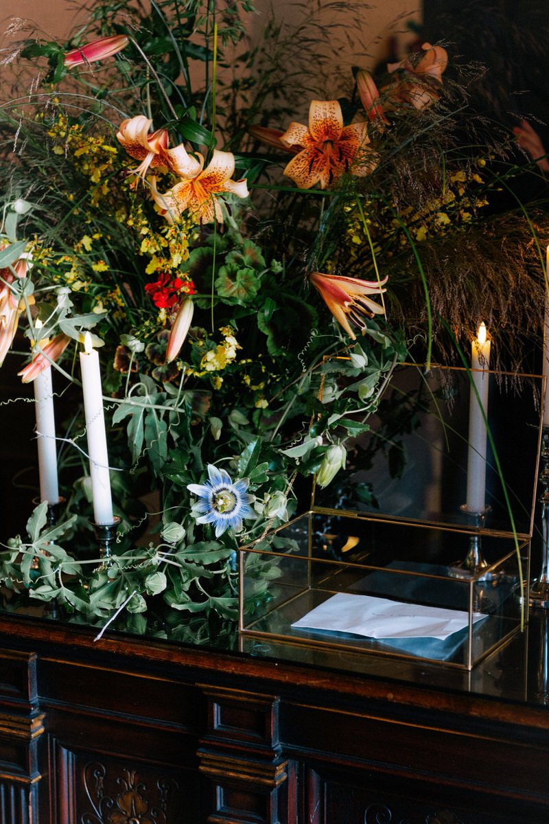 abstract floral arrangement with orange lilies and blue passion flower