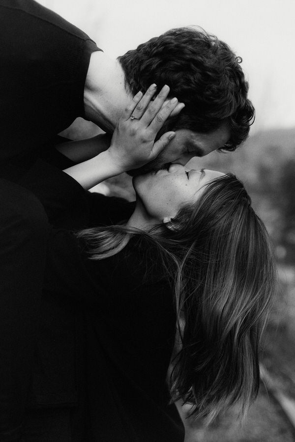romantic editorial photo of mixed race couple kissing