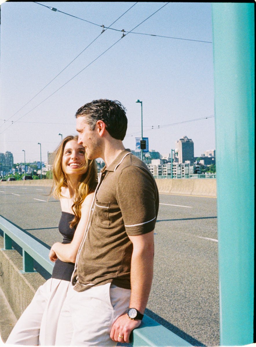 35mm photo of engaged couple on Cambie Street Bridge in Vancouver