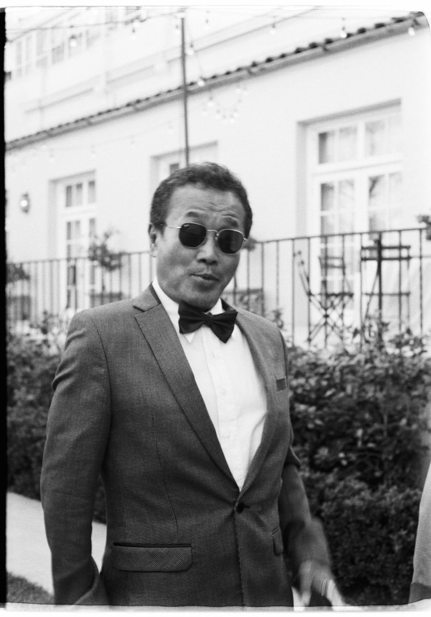 35mm film photo of fun and fashionable wedding guest during a cocktail reception at Ebell of LA