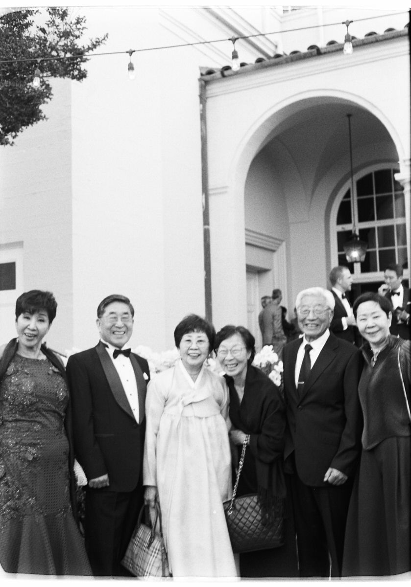 35mm film photo of older fashionable Korean wedding guests in Los Angeles