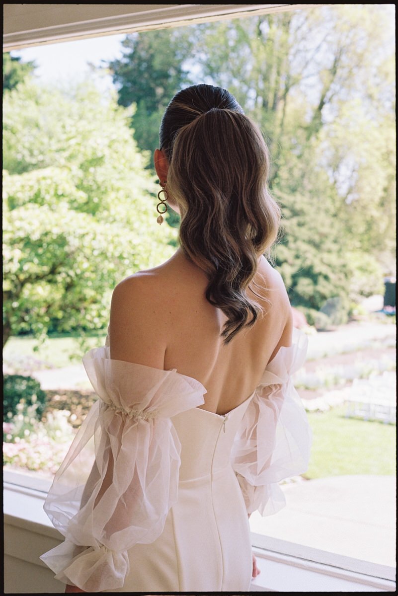 35mm film photo of bride wearing Sarah Seven and hair in a ponytail