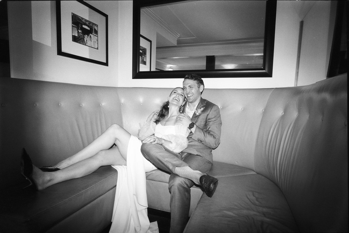 35mm film photo of happy wedding couple using direct flash